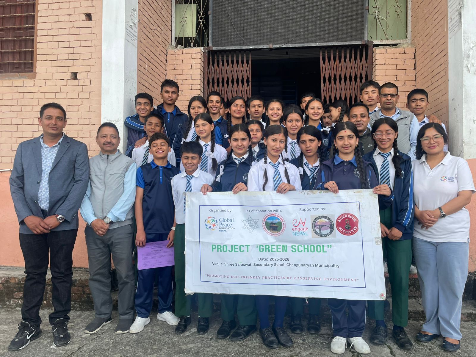 Students and partners with a project banner